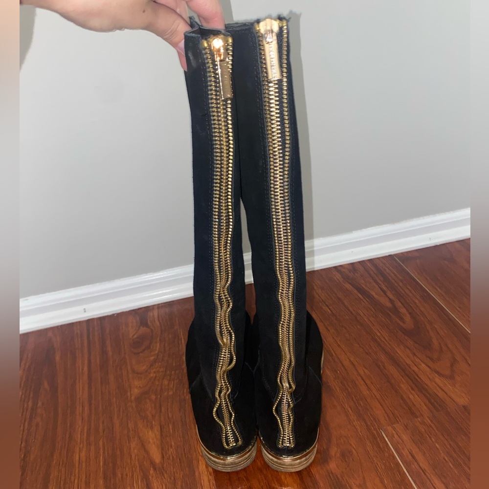 Modern Vice. Tall black boots.